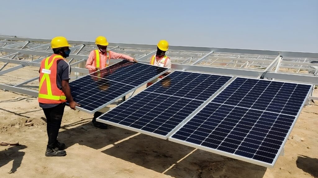 Workers fixing Solar Panels.